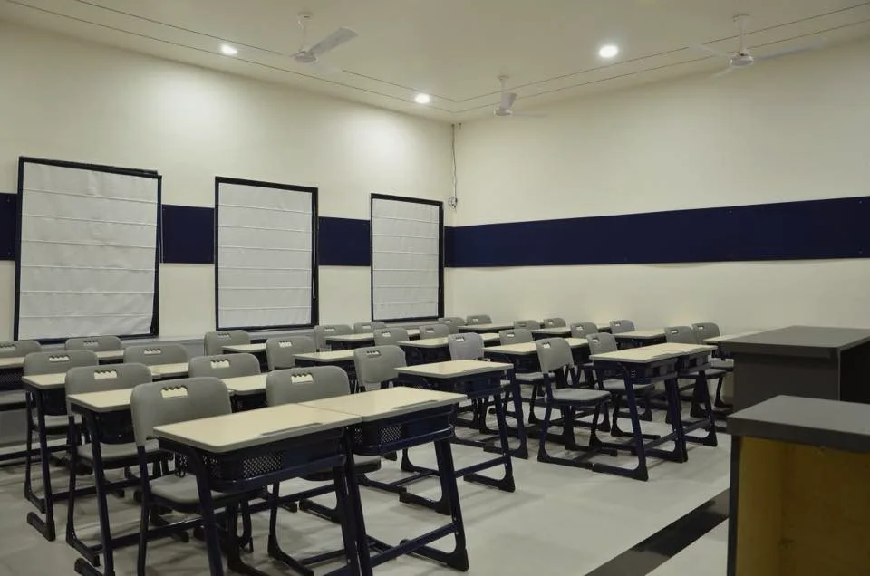 Rows of desks and chairs inside a school classroom
